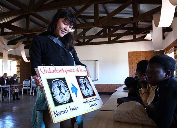 ザンビアにおけるスピルリナ栄養教育教材開発プロジェクトで脳の発達の違いを見ている生徒たち。かなりインパクトがあった様子。ss